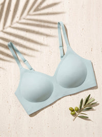 Kiri Brielle Blue wireless bra on pale travertine with palm shadow 1