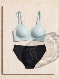 Kiri Brielle Blue bra with Nisha Black daywear period underwear as a set on travertine 5