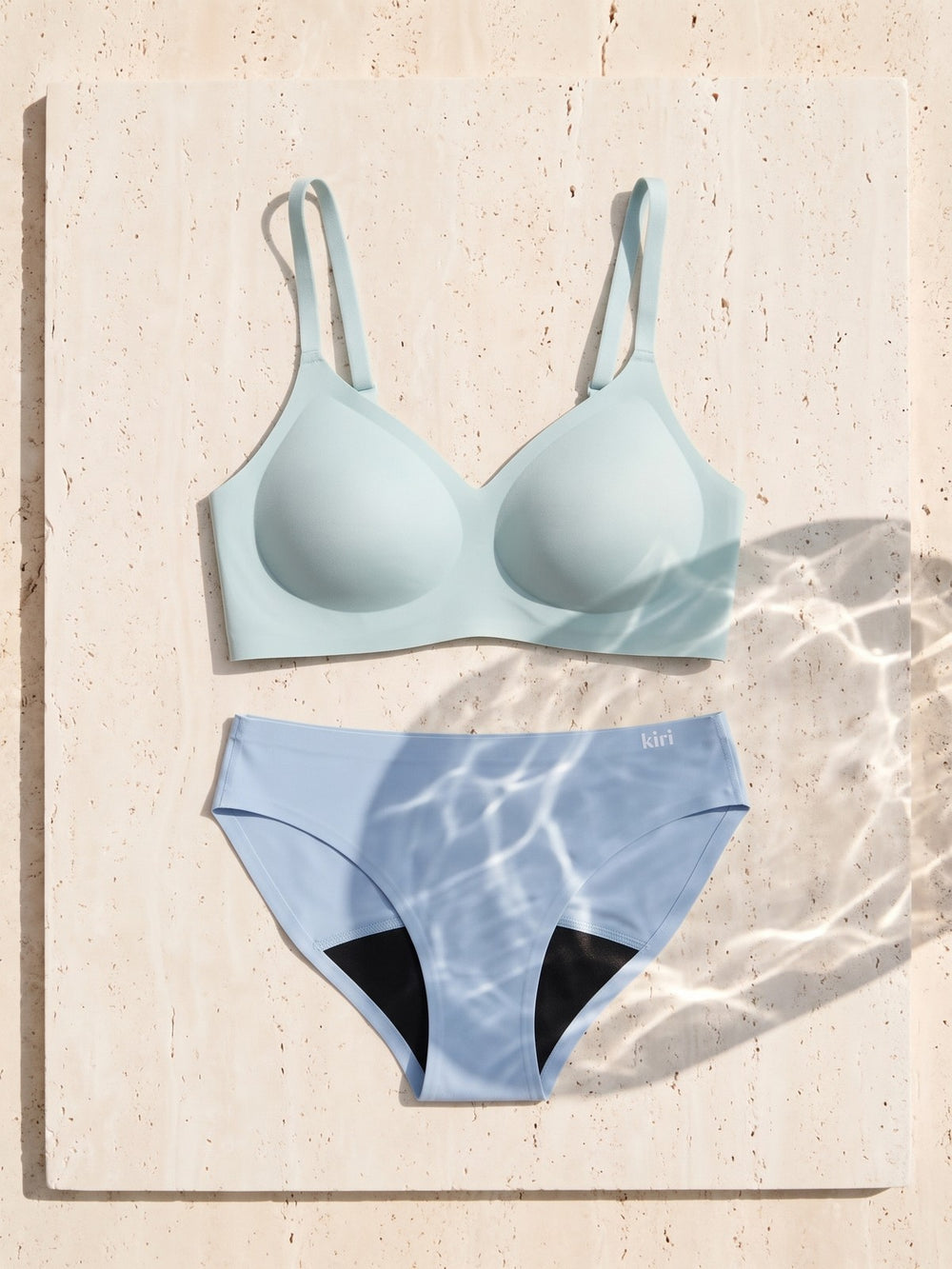 Kiri Brielle Blue bra with Celeste Blue daywear period underwear as a set on travertine
