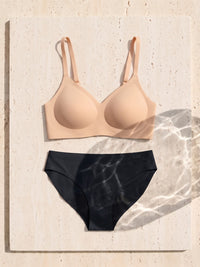 Kiri Charlotte Nude bra with Nisha Black daywear period underwear as a set on travertine 5