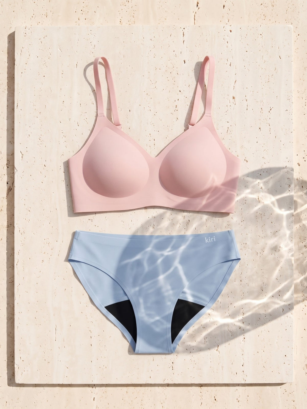 Kiri Heather Pink bra with Celeste Blue daywear period underwear as a set on travertine