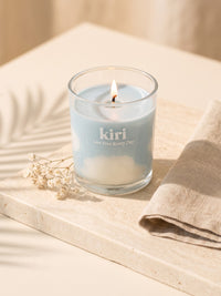 Kiri Live Free Every Day candle lit on pale travertine 1