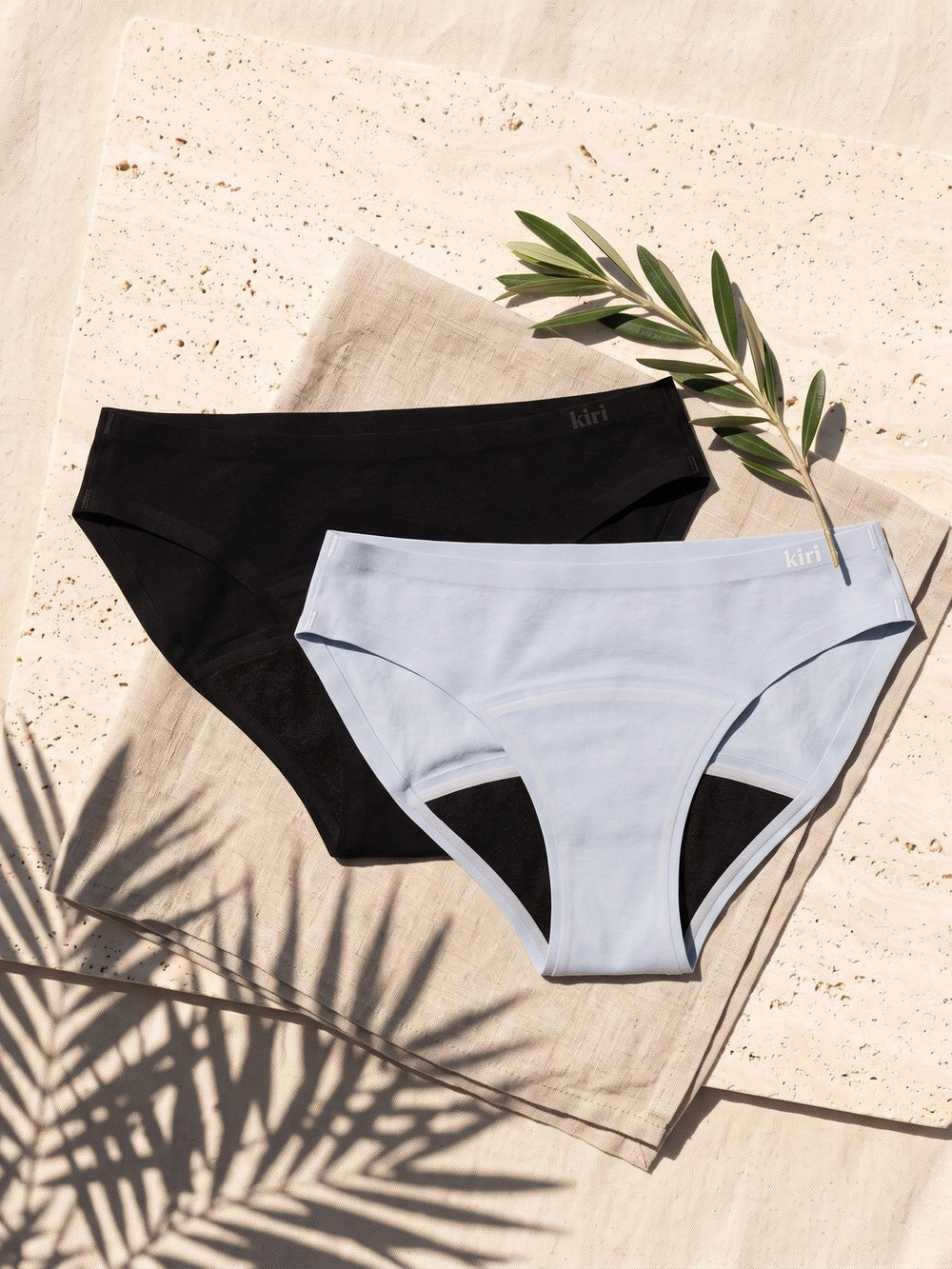 Daywear Panties Duo: Celeste Blue and Nisha Black period underwear on linen and travertine