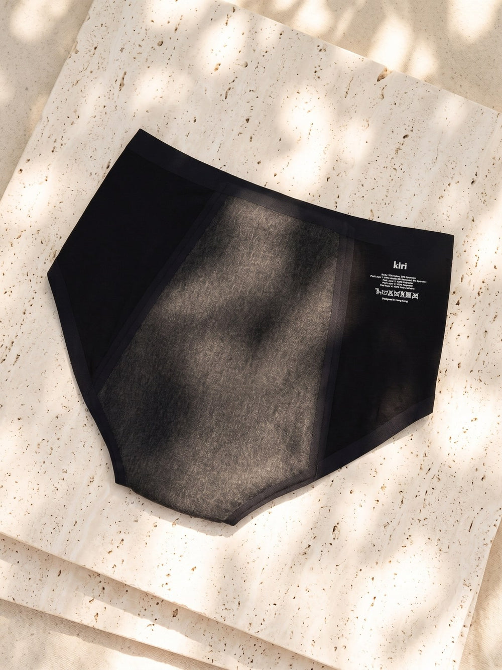 Back of Kiri Selene Black nightwear period underwear in dappled sunlight