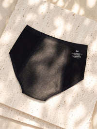 Back of Kiri Selene Black nightwear period underwear in dappled sunlight 1