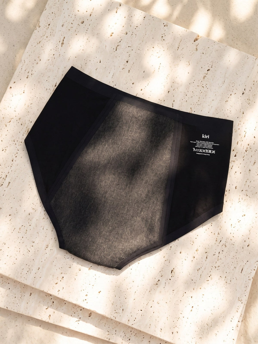 Back of Kiri Selene Black nightwear period underwear in dappled sunlight